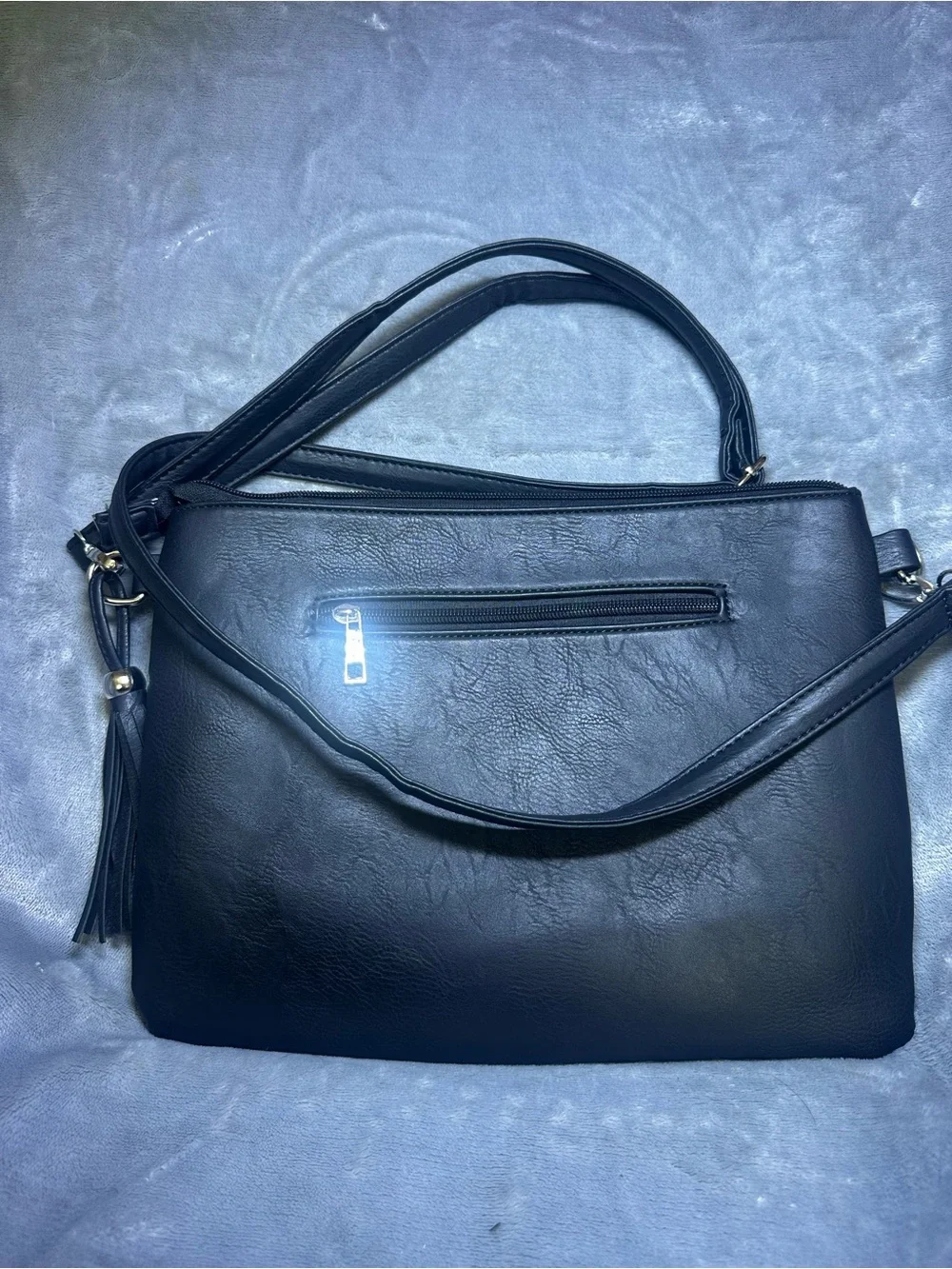 Black Studded Crossbody Bag with Skull Accents and Tassel Detail